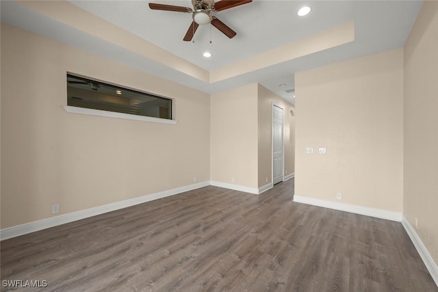 908 SW Embers Ter, Cape Coral, FL 33991 - spare room with ceiling fan, wood finished floors, a tray ceiling, and recessed lighting