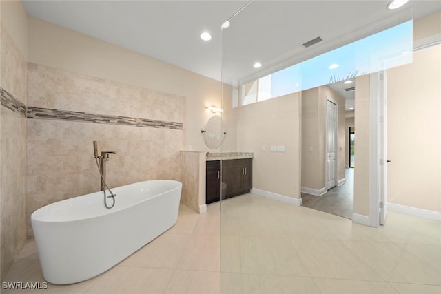 908 SW Embers Ter, Cape Coral, FL 33991 - full bathroom featuring vanity, a freestanding bath, tile patterned floors, and recessed lighting