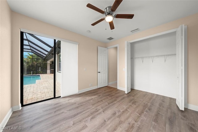 908 SW Embers Ter, Cape Coral, FL 33991 - unfurnished bedroom with wood finished floors, ceiling fan, and access to exterior