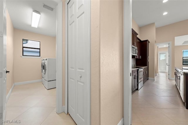 908 SW Embers Ter, Cape Coral, FL 33991 - hall with washing machine and dryer, light tile patterned floors, healthy amount of natural light, and recessed lighting