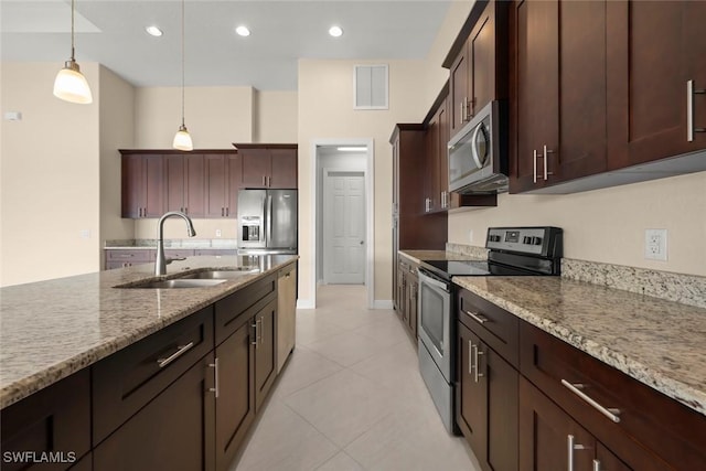 908 SW Embers Ter, Cape Coral, FL 33991 - kitchen with appliances with stainless steel finishes, hanging light fixtures, light stone countertops, and recessed lighting