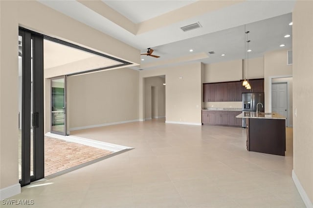 908 SW Embers Ter, Cape Coral, FL 33991 - unfurnished living room with a ceiling fan, light tile patterned floors, recessed lighting, and a towering ceiling