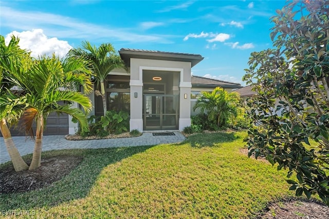 entrance to property with a yard and a garage