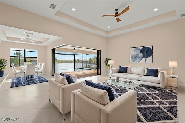 908 SW Embers Ter, Cape Coral, FL 33991 - living area featuring a tray ceiling, ceiling fan, recessed lighting, and light tile patterned floors