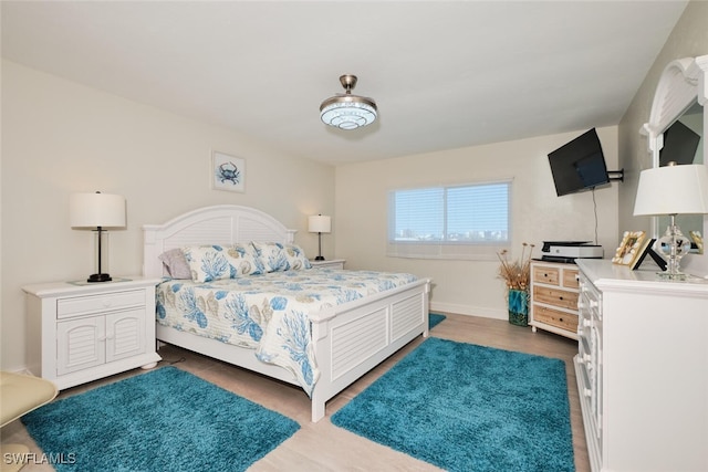 bedroom with dark hardwood / wood-style flooring