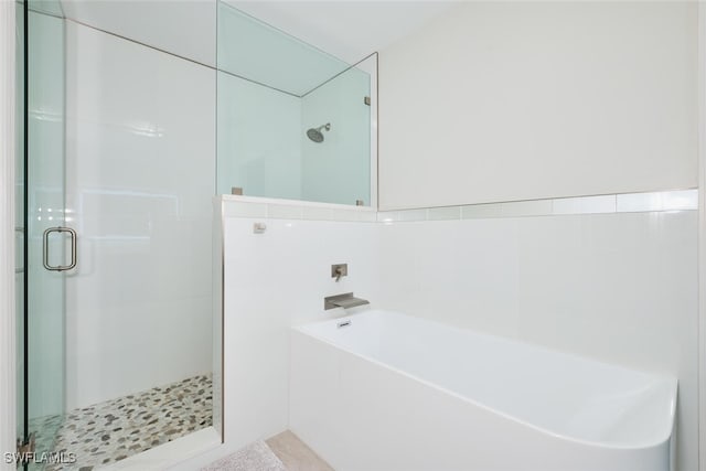 bathroom with separate shower and tub