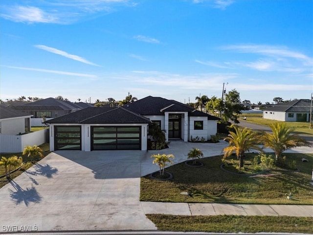 view of front facade with a garage and a front yard