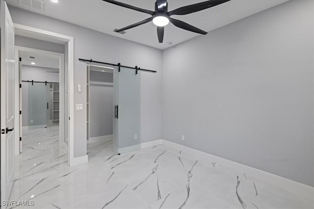 bedroom with a barn door and ceiling fan