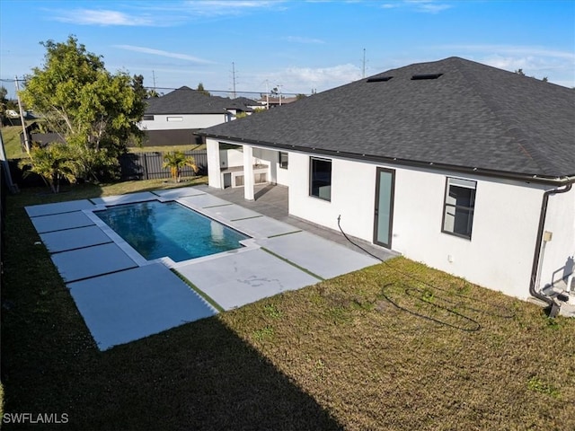 view of swimming pool with a yard and a patio