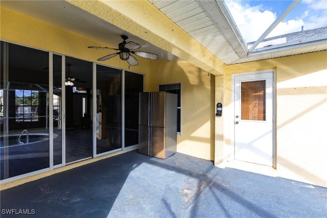 doorway to property featuring ceiling fan and a patio area