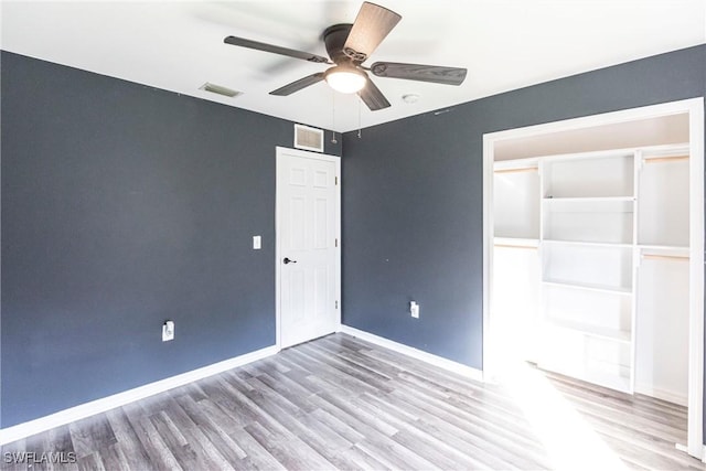 unfurnished bedroom featuring ceiling fan and hardwood / wood-style floors