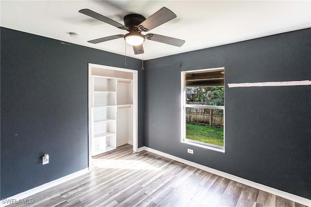 empty room featuring ceiling fan and wood-type flooring