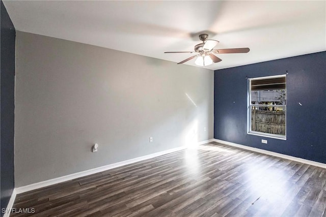 empty room featuring dark wood-type flooring and ceiling fan