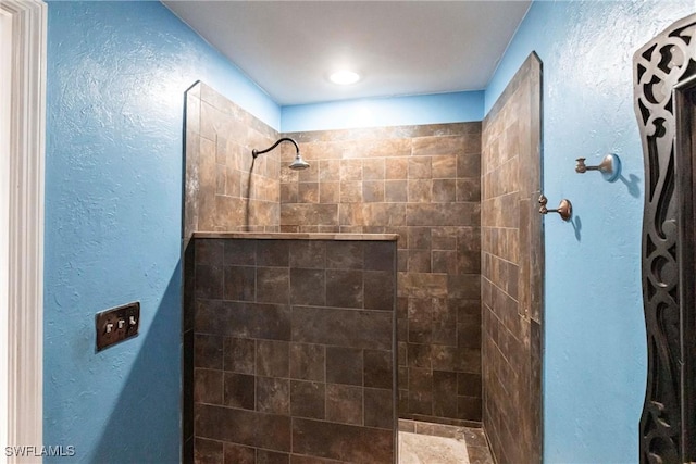 bathroom with tiled shower