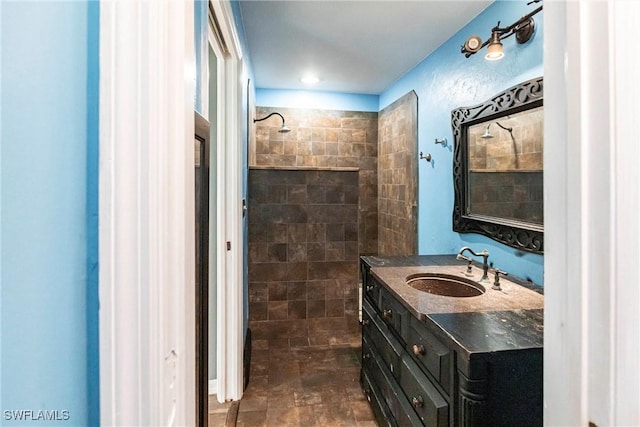 bathroom with vanity and tiled shower