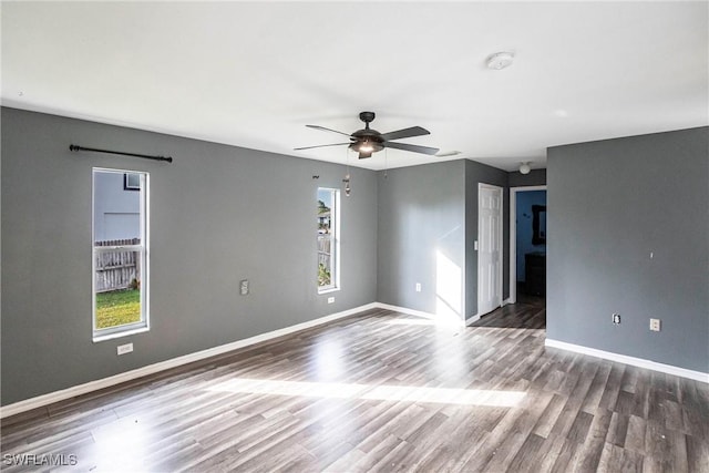 unfurnished room featuring ceiling fan and dark hardwood / wood-style flooring