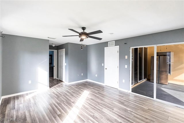 spare room featuring ceiling fan and light wood-type flooring