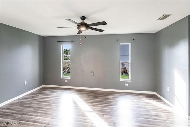 empty room with hardwood / wood-style flooring and ceiling fan