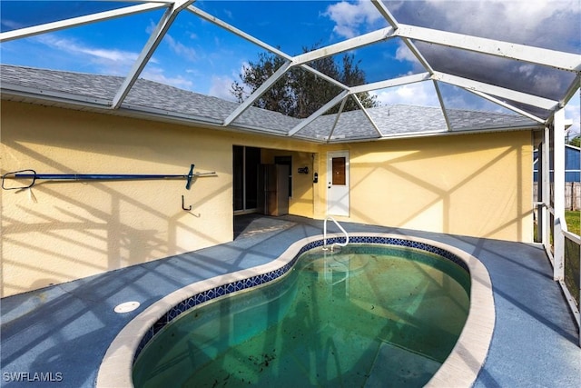 view of pool with a lanai and a patio