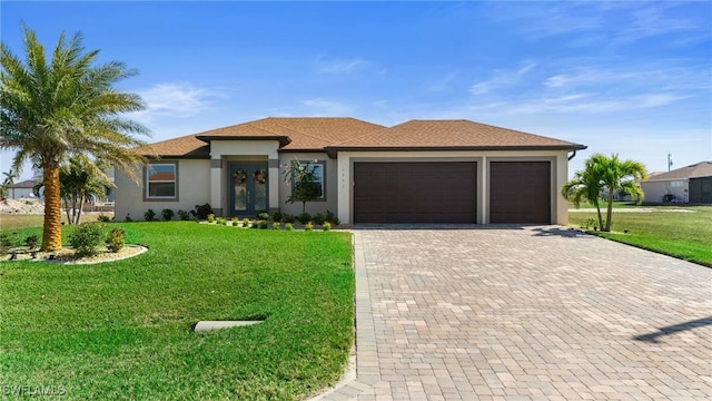 view of front of home with a garage, a front lawn, and french doors