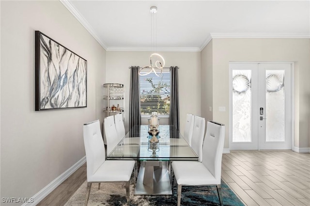 dining area featuring french doors, crown molding, and hardwood / wood-style flooring