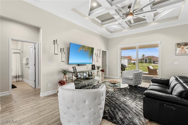 living room with coffered ceiling, light wood-type flooring, beamed ceiling, ceiling fan, and a high ceiling