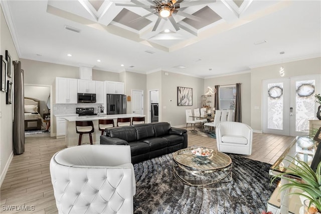 living room with light wood-type flooring, coffered ceiling, crown molding, beam ceiling, and french doors