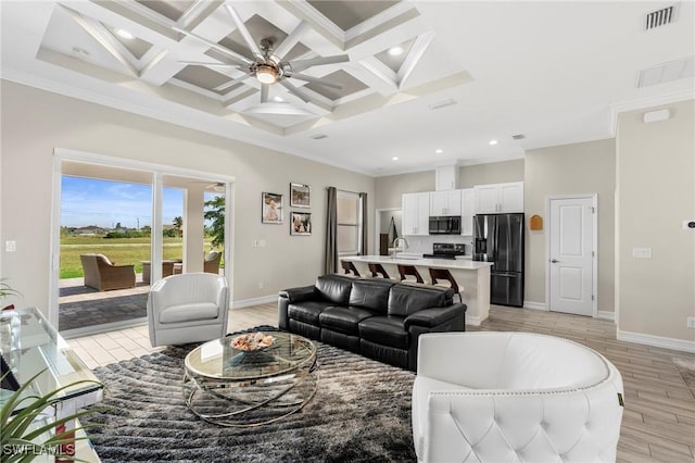 living room featuring ornamental molding, coffered ceiling, light hardwood / wood-style floors, and beam ceiling