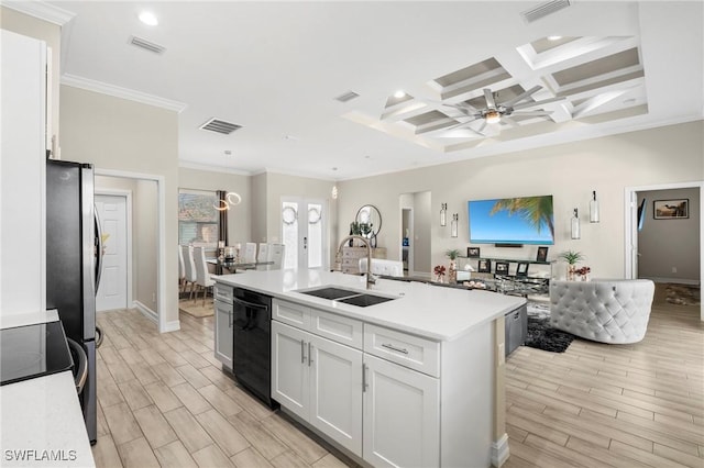 kitchen with white cabinetry, sink, black dishwasher, and a center island with sink