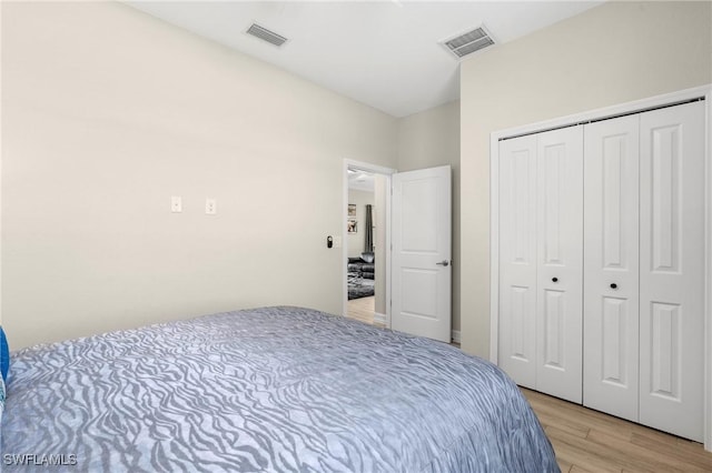 bedroom featuring a closet and light wood-type flooring