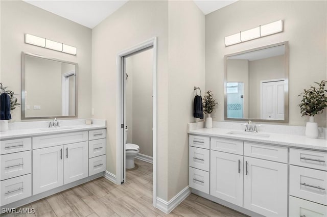 bathroom featuring hardwood / wood-style flooring, vanity, and toilet