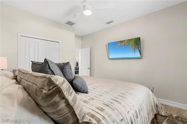 bedroom with ceiling fan, wood-type flooring, and a closet