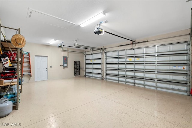 garage featuring a garage door opener and electric panel