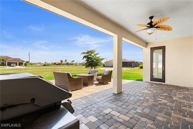 view of patio / terrace with ceiling fan and an outdoor living space