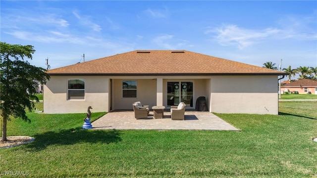 back of property with a yard and a patio