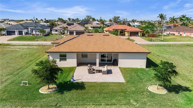 back of house featuring a lawn, outdoor lounge area, and a patio