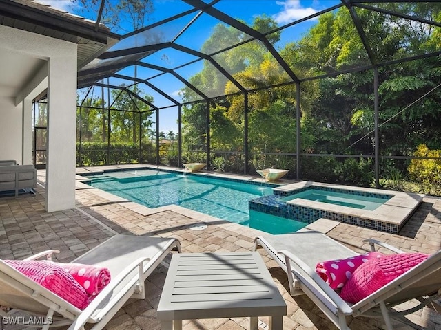 view of swimming pool with an in ground hot tub, a lanai, and a patio