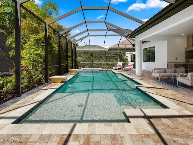 view of swimming pool featuring an in ground hot tub, a patio, an outdoor hangout area, and glass enclosure