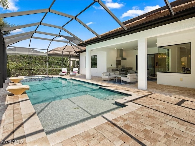 view of swimming pool with a patio, a lanai, an outdoor hangout area, and an in ground hot tub