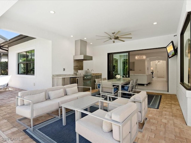 living room featuring ceiling fan with notable chandelier