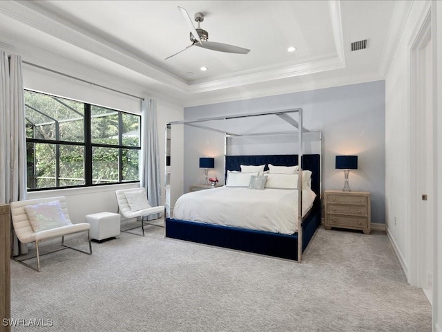 bedroom featuring light carpet, crown molding, and a raised ceiling