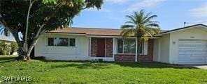 ranch-style home with a garage and a front yard