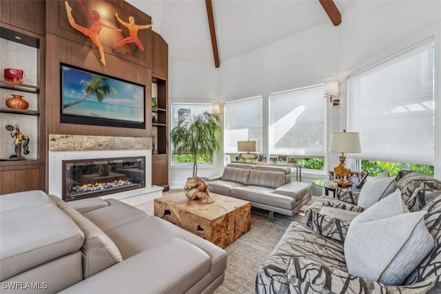 living room featuring high vaulted ceiling, built in features, and beam ceiling