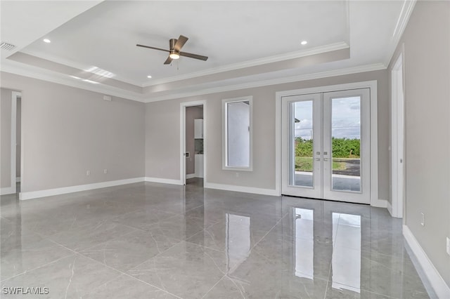 empty room with french doors, ceiling fan, crown molding, and a raised ceiling