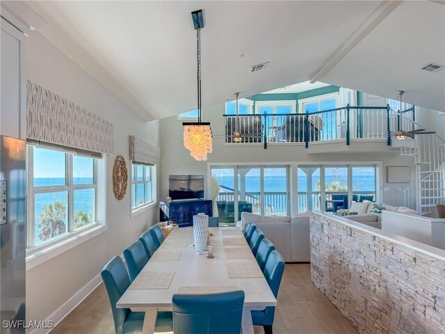4611 Seair Ln, Upper Captiva, FL 33924 - dining space featuring beamed ceiling, high vaulted ceiling, and light wood-type flooring