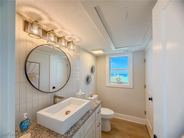 4611 Seair Ln, Upper Captiva, FL 33924 - bathroom with vanity, wood-type flooring, tile walls, and toilet
