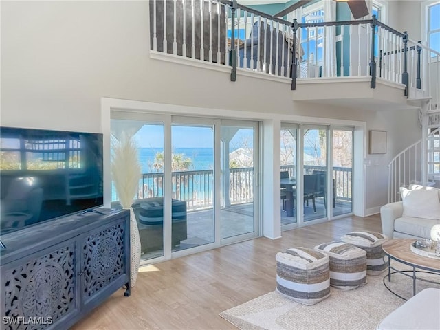 4611 Seair Ln, Upper Captiva, FL 33924 - living room featuring a water view, wood-type flooring, and a high ceiling