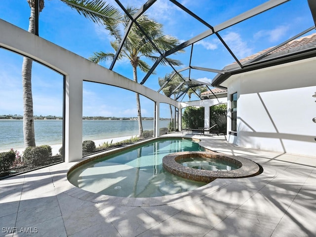 view of pool featuring an in ground hot tub, a patio, glass enclosure, and a water view