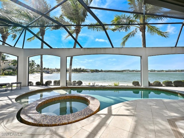 view of swimming pool featuring a lanai, a patio area, an in ground hot tub, and a water view