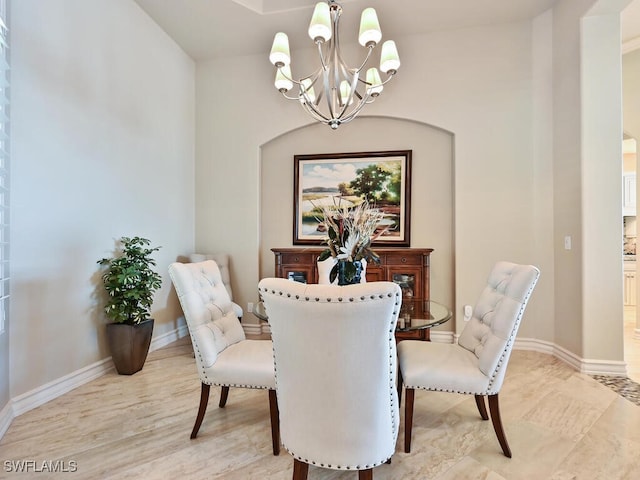 dining space featuring an inviting chandelier and light hardwood / wood-style floors